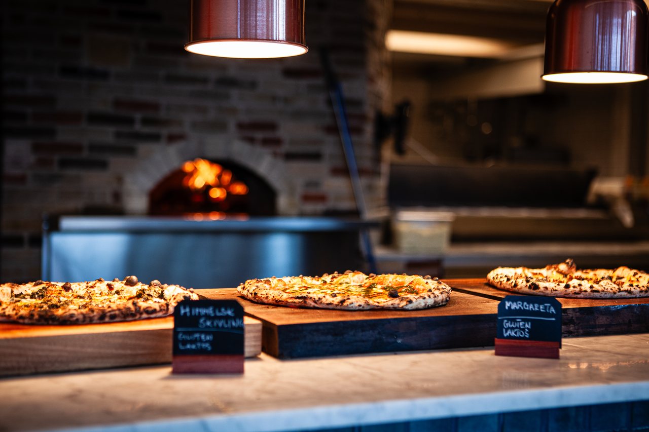 The lunch buffet: freshly baked pizzas laid out in front of the wood-fired oven