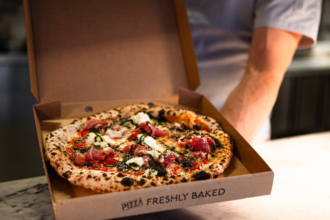 Freshly baked pizza in a box, ready to collect